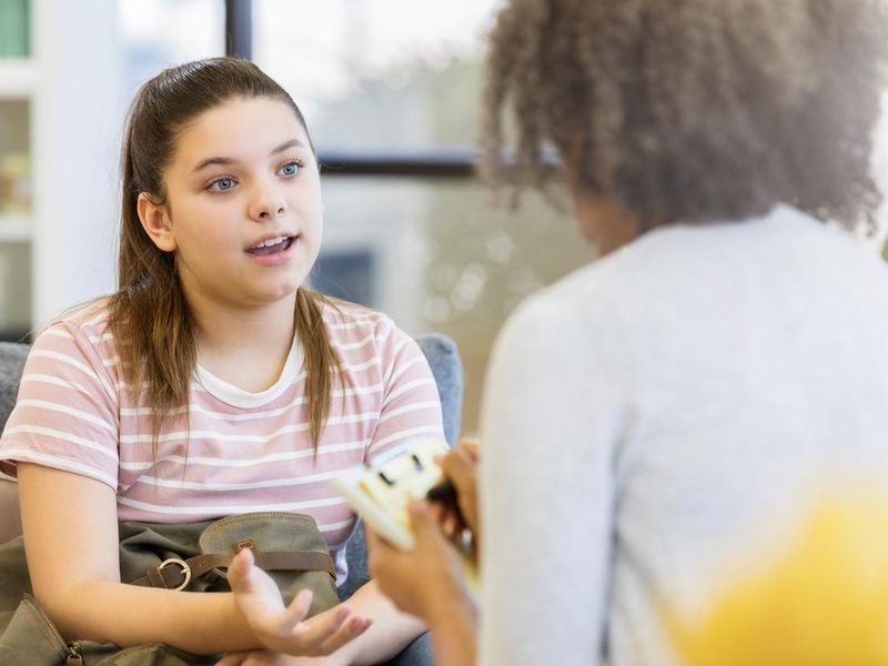 Teenage girl talks to school counselor
