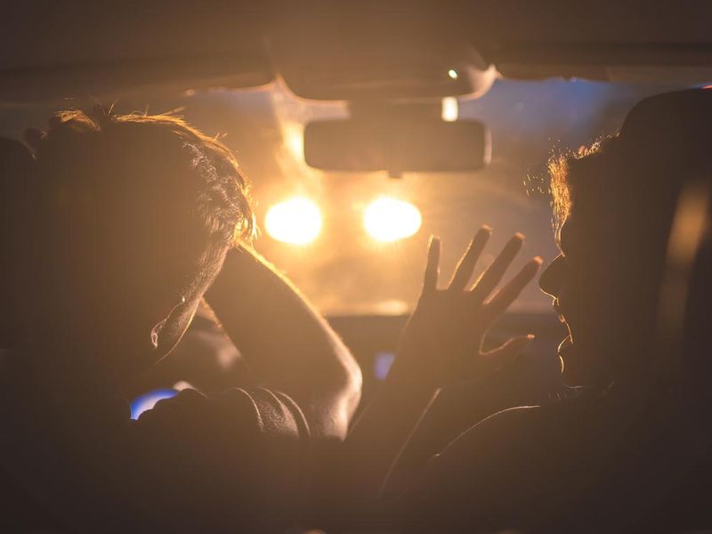 The man and woman drive a car in emergency situation. evening night time