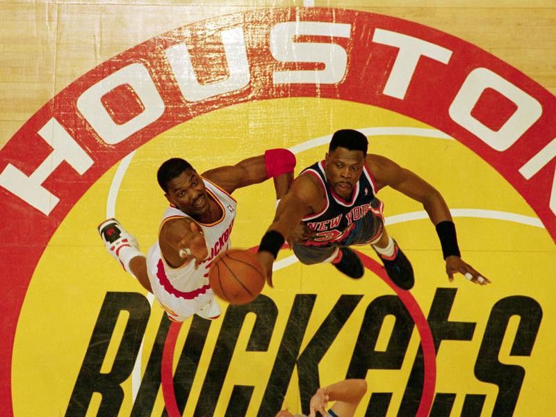 The New York Knicks’ Patrick Ewing and the Houston Rockets’ Hakeem Olajuwon go for opening tip
