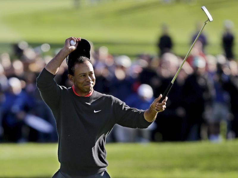 Tiger Woods celebrates after winning Farmers Insurance Open golf tournament