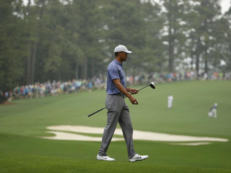 Tiger woods walking with golf club