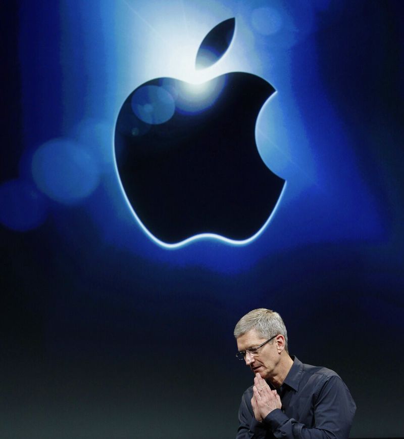 Tim Cook, CEO of Apple and Apple logo