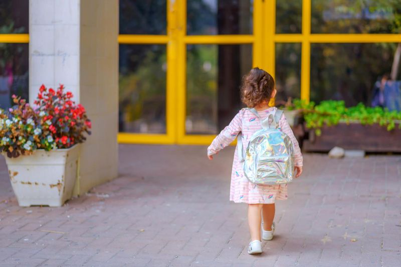 Toddler on the first day of preschool wearing a toddler backpack