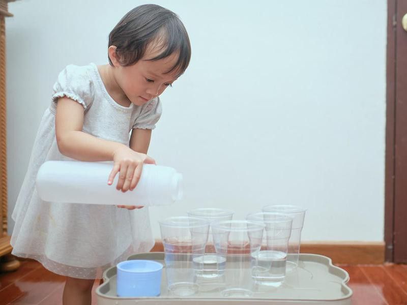 Toddler playing with cups