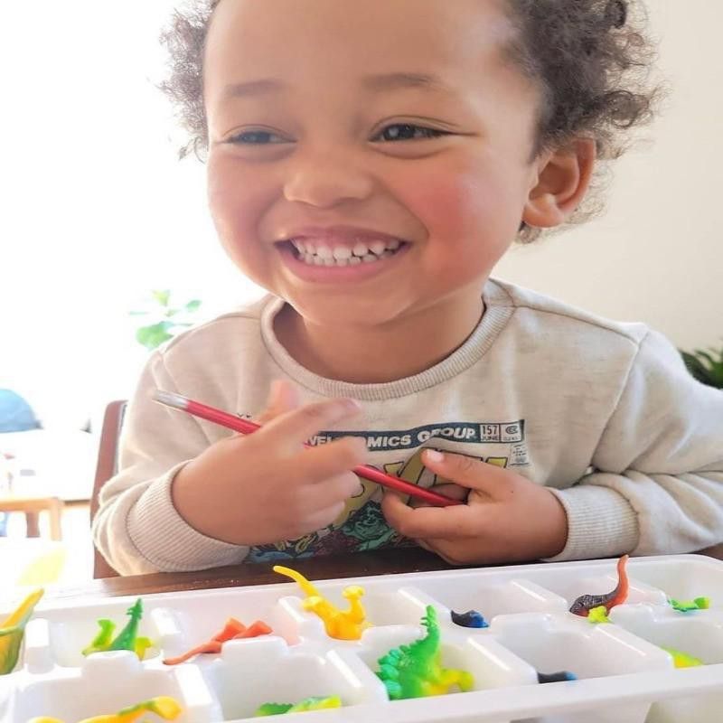 Toddler playing with ice cube tray