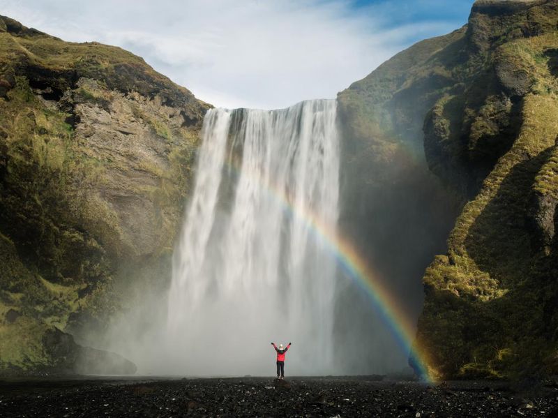 tourist in an Icelandic waterfall