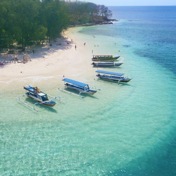 Image of tourist ships anchored on the Gili Rengit beach at Lombok, Indonesia