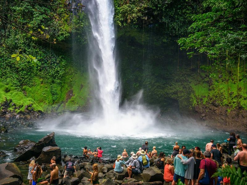 Tourists and locals visiting La Fortuna waterfall in Costa Rica
