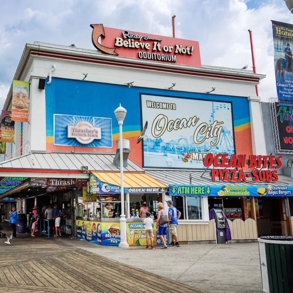Ocean City, MD/USA - August 2, 2022: Tourists walk along the shops, attractions and food establishments on the boardwalk at Ocean City, Maryland in the summer