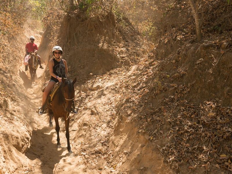 Tourists ride horses in Puerto Vallarta, Mexico