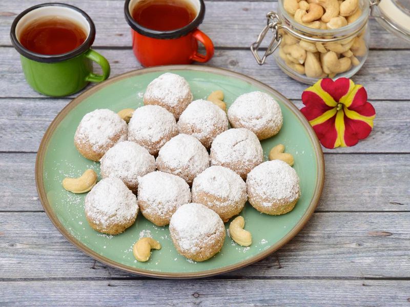 Traditional Christmas cashew snowballs cookies biscuits covered icing sugar powder.