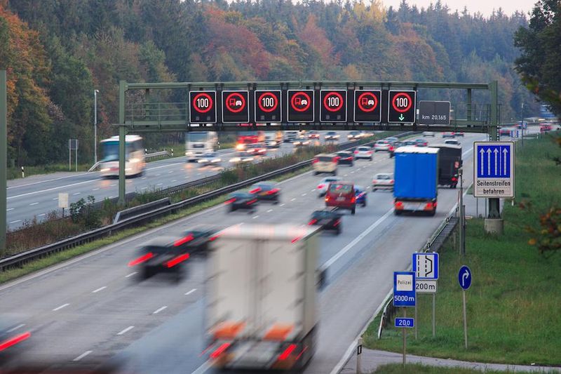 Traffic on german autobahn with speed limit signs