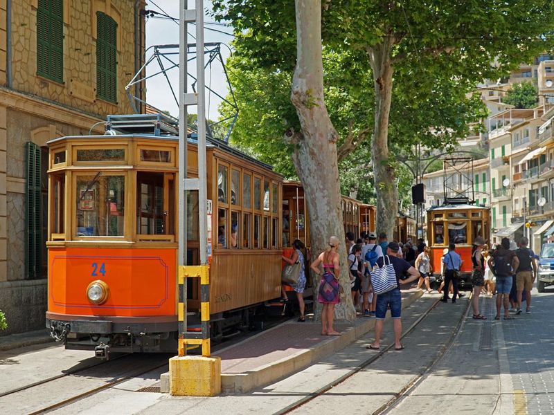 Trams and travelers in Soller, Mallorca, Spain