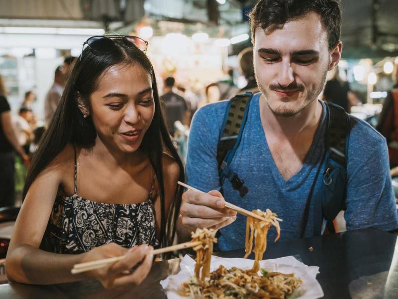 Travelers eating street food