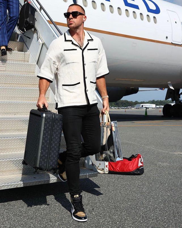 Travis Kelce walking off plane