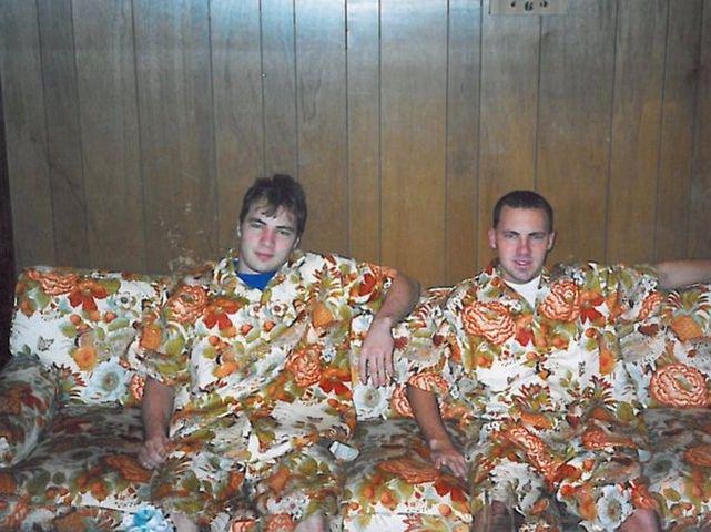 Two brothers in outfits that match the couch