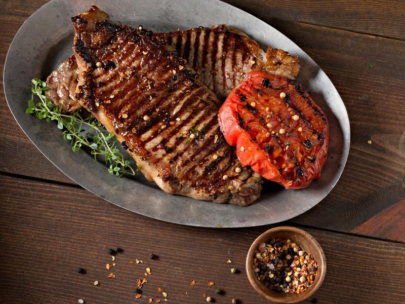 Two Grilled New York Strip Steaks On A Platter