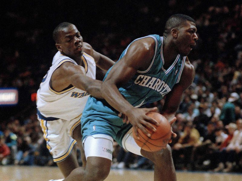 Tyrone Hill defends against Larry Johnson