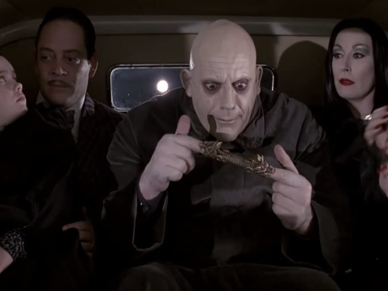 Uncle Fester playing with a children's toy