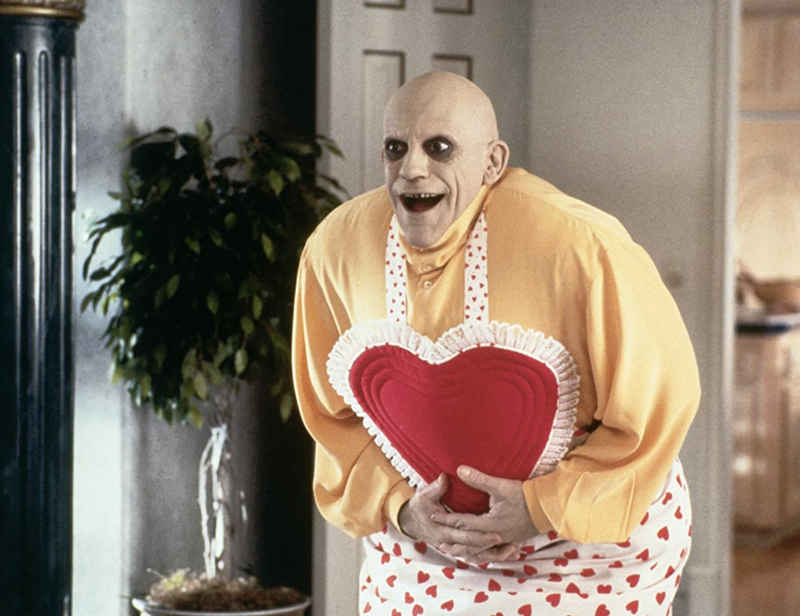 Uncle Fester wearing a Valentine's Day Apron