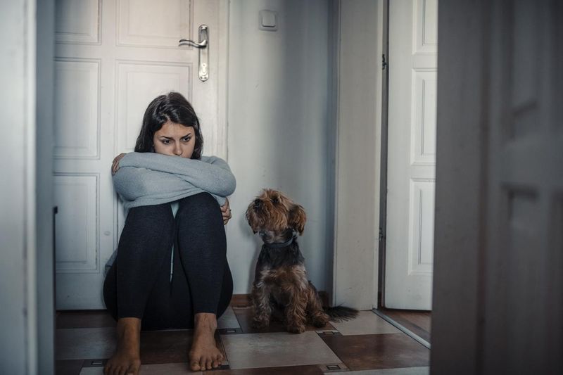 Upset woman next to worried dog