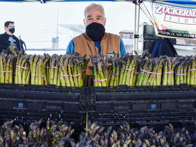 Vendor selling asparagus at the Ferry Plaza Farmers Market
