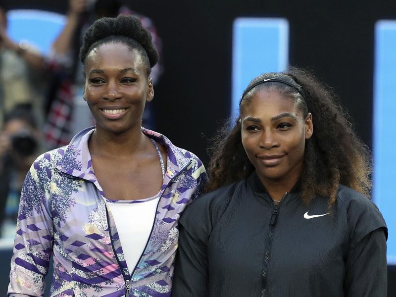 Venus and Serena Williams pose ahead of women's singles final