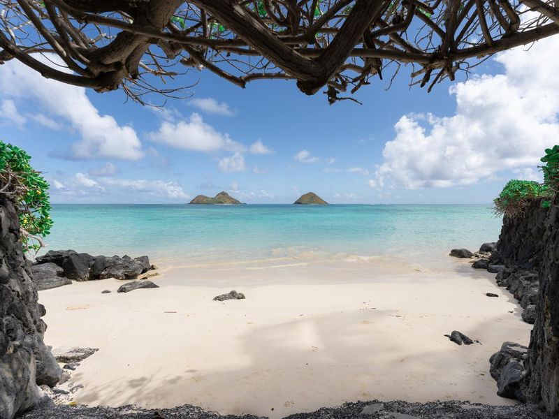 View of the twin islands of Na Mokulua from Lanikai Beach in Kailua, Hawaii, USA