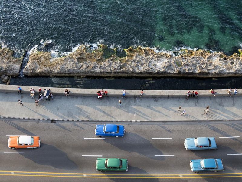 Vintage American Cars Speeding along the Malecon in Havana, Cuba