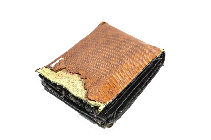 Vintage or Old wallet brown torn isolated on white background