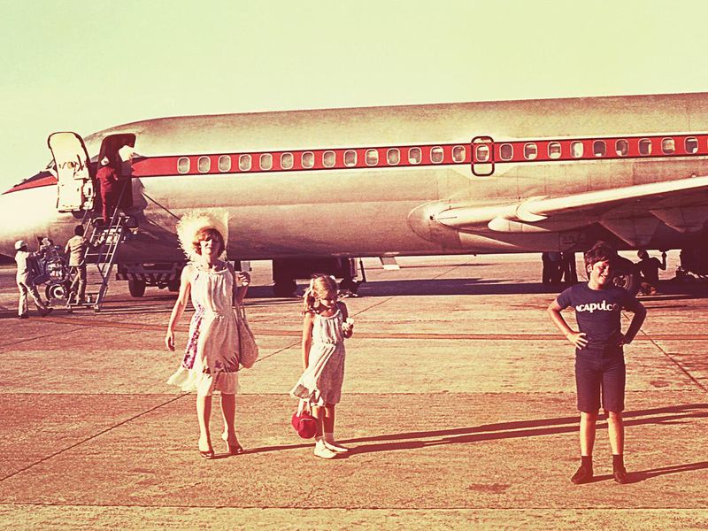 Vintage photo of a family boarding an airplane