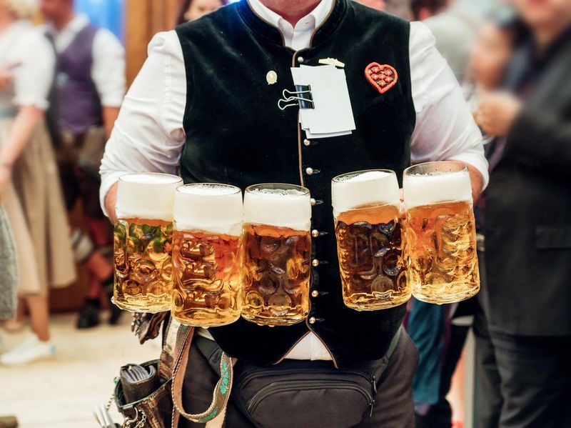 Waiter carrying beer glasses at Octoberfest in Munich