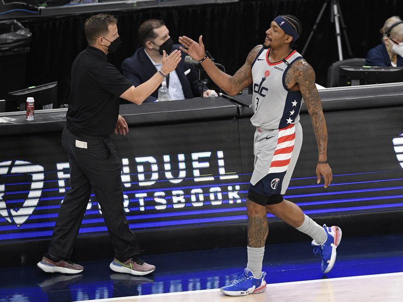 Washington Wizards guard Bradley Beal reacts with head coach Scott Brooks
