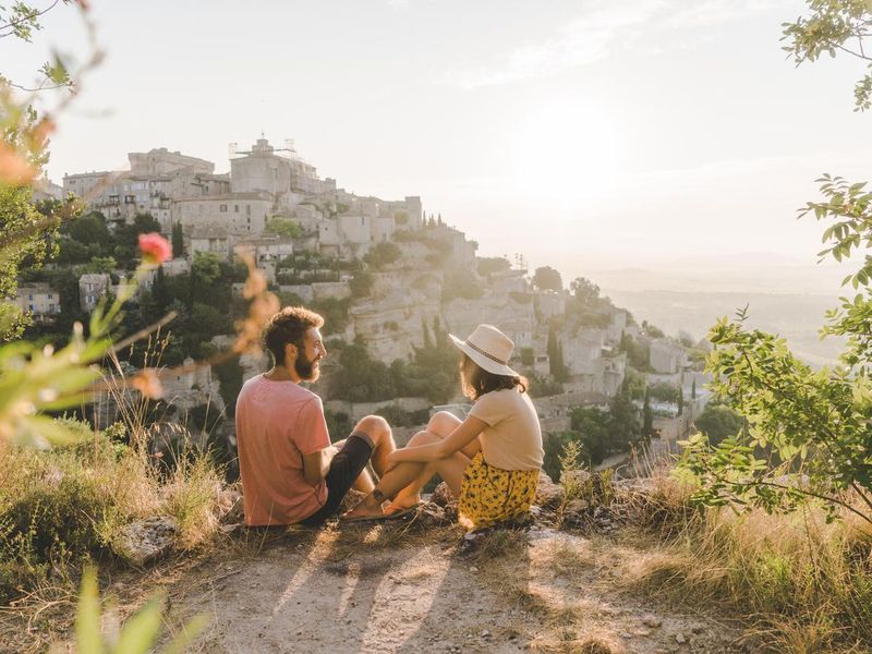 Woman and man looking at scenic view  of Gordes village in Provence