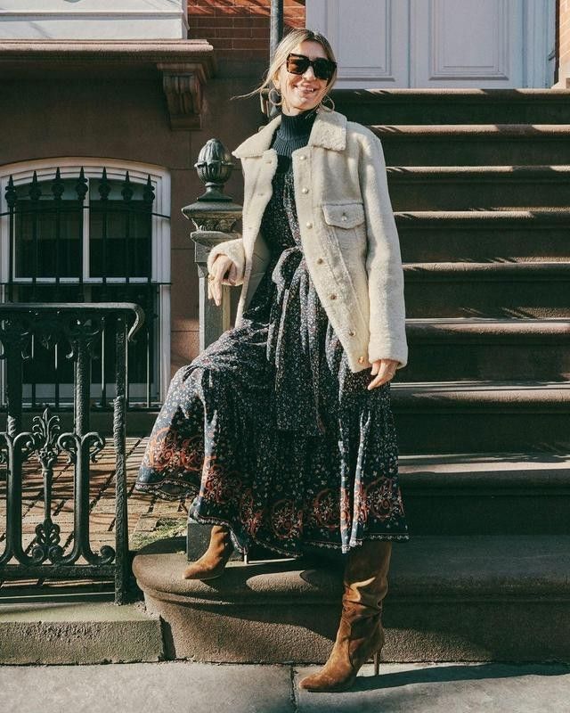Woman in print dress by stoop steps