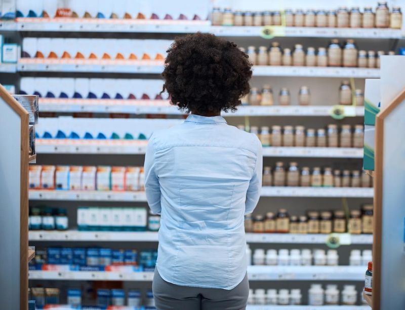 Woman looking at medications on the shelf