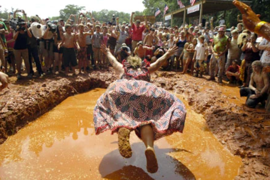 Woman mud-pit belly flopping