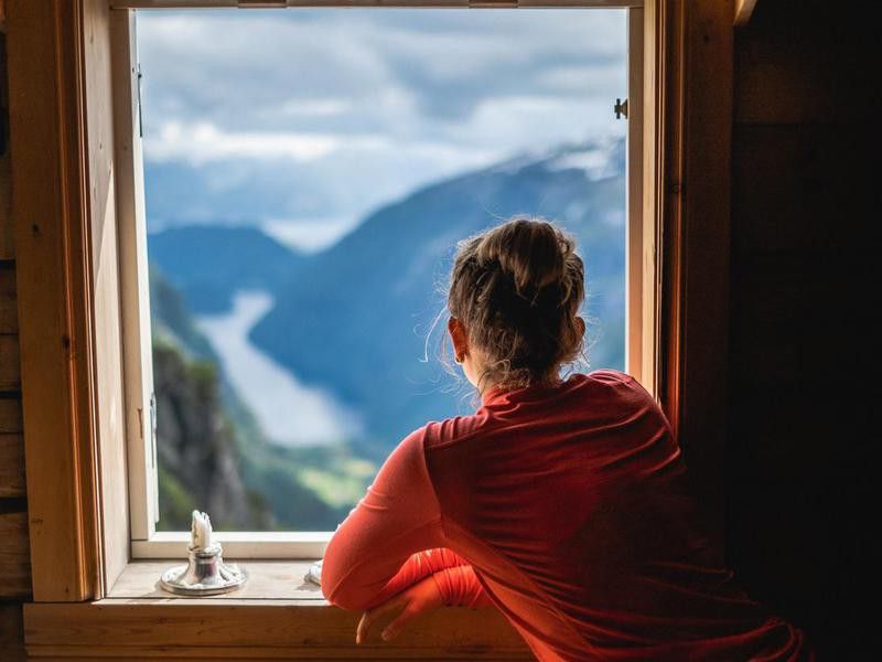 Woman overlooking fjord in Norway