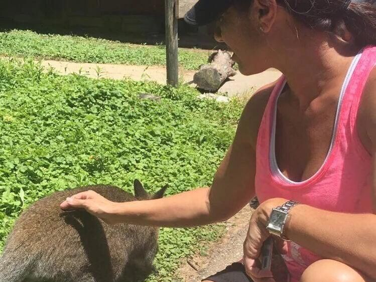 Woman petting a wallaby