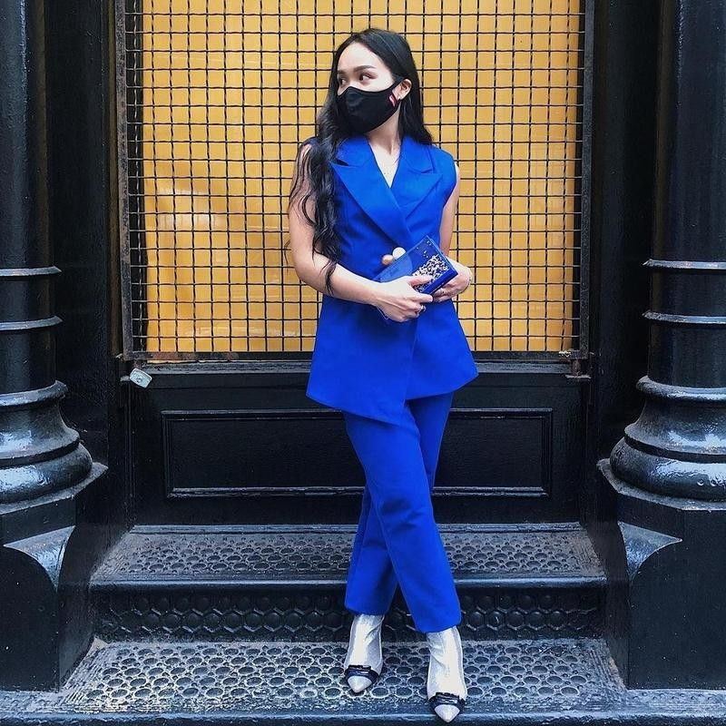 Woman poses in blue suit