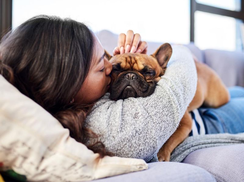 Woman snuggling an emotional support pet