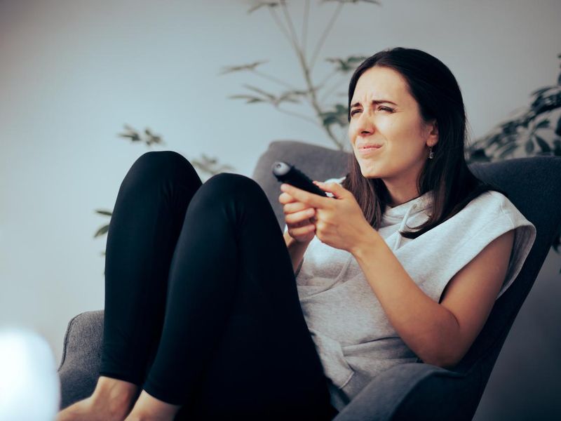 Woman Squinting while Watching TV Needing Her Eyeglasses to See