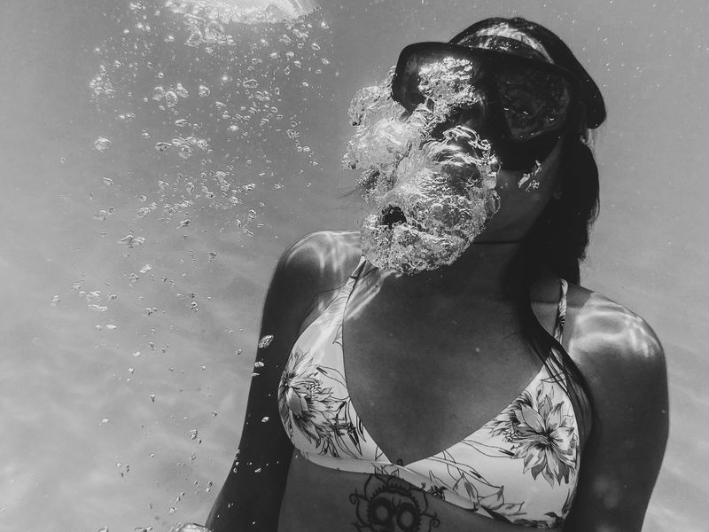 Woman swimming underwater on a trip