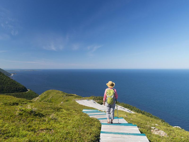 Woman walking, hiking, Skyline, Cabot trail, Cape Breton, Nova Scotia