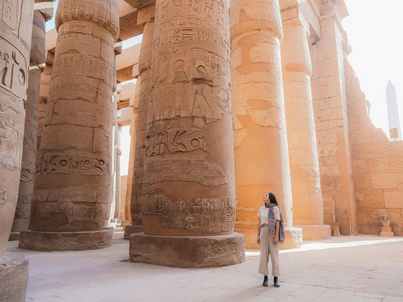 Woman walking in the ancient Egyptian temple in Luxor