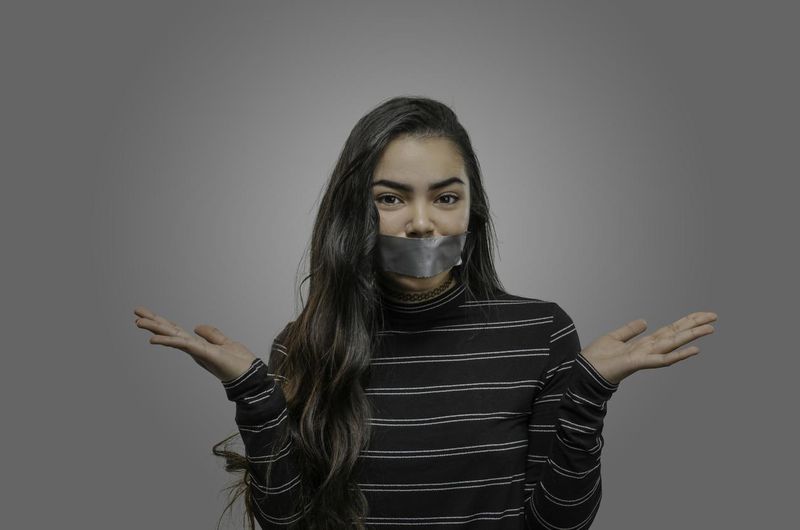 Woman with mouth taped shut