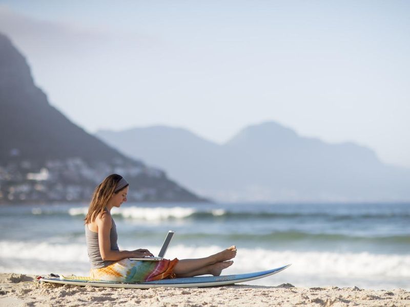 Woman working on the beach in Cape Town