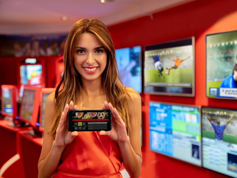 Women holding smartphone with sports betting app