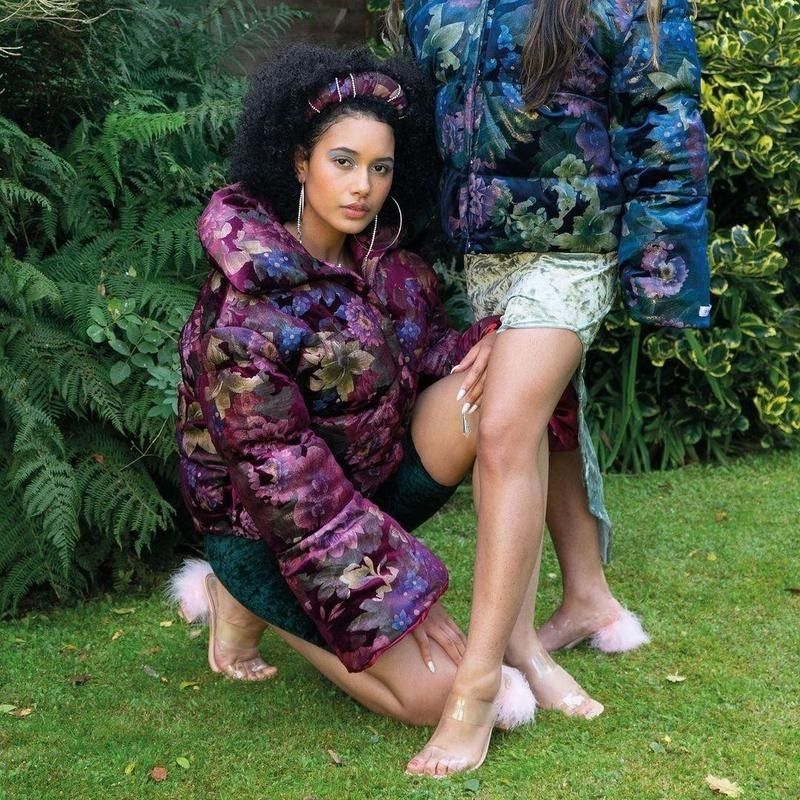 Women in floral jackets on grass
