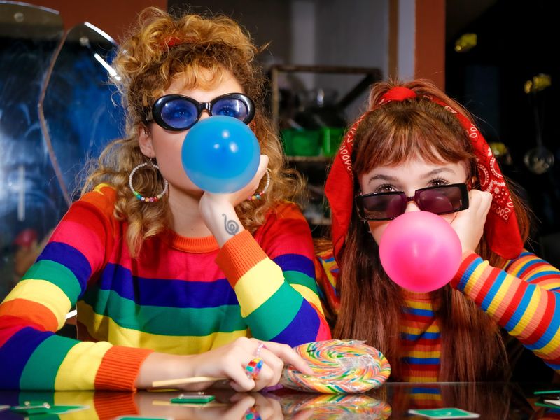 Women showing enthusiasm for bubble gum facts, history and trivia